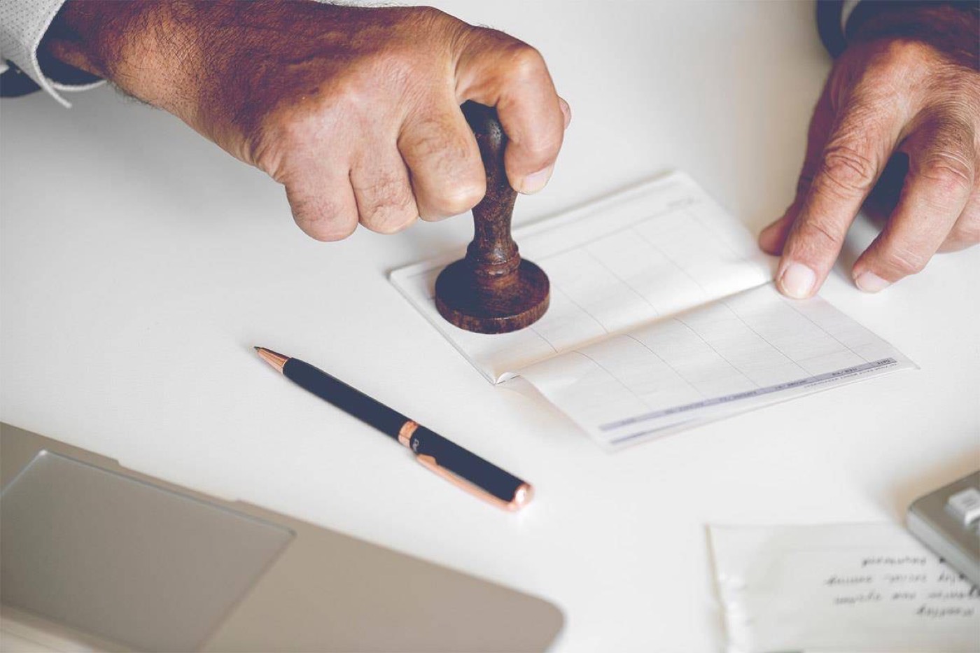 A notary seal and pen resting on a document